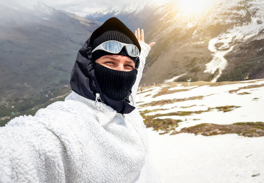 Young woman enjoying mountain hike and taking selfie