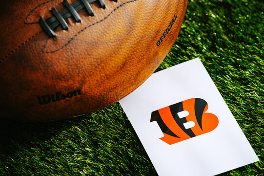 Cincinnati Bengals team Logo and American football ball on Green Grass.