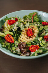 Salad with dressing and fresh vegetables