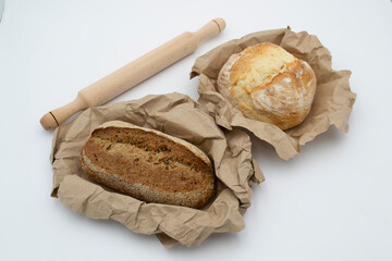 black and white bread. fresh baked bread.  rolling pin for dough. sliced ​​black bread.