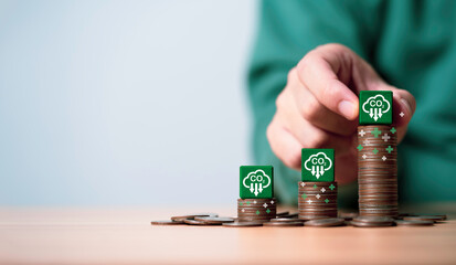 Businessman stacking CO2 reducing icon on increasing coins for decrease CO2 , carbon footprint and...