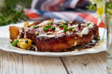 Grilled bone in pork chops with potato,