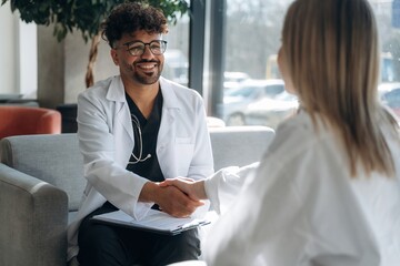 Consultation with doctor. Man and woman are indoors in modern building
