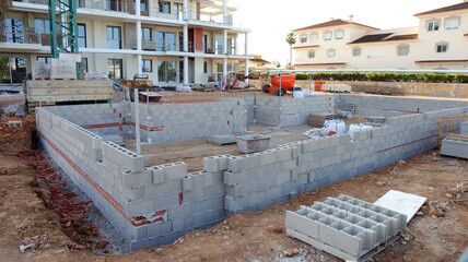 Construction begins on swimming pool near residential building site 