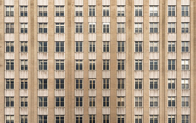 Full frame of grid-like building facade with windows. Urban structure and repetition concept.  
