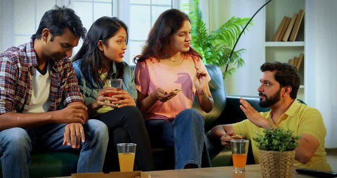 Indian Friends having pizza and engaging in deep conversation, Asian young close friends sitting on cozy sofa in modern home, enjoying food, bonding, laughing, sharing thoughts while relaxing indoors