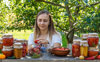 Woman Preserving Tomatoes and Vegetables in Garden