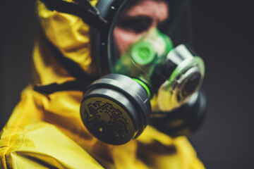 Worker in Protective Suit With Gas Mask During Safety Drill in Industrial Setting