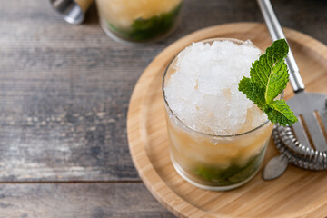 Classic Mint Julep Cocktail on wooden table. Copy space