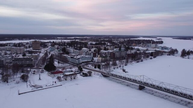 Bridge Over Frozen Torne River At Tornio City In Finland During Winter. Aerial Drone Shot