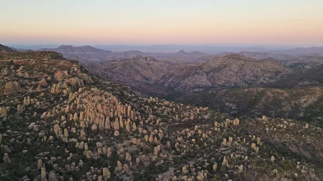 Tall rock formations at Valle de los Monjes near Creel, Mexico, during golden hour