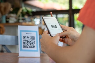 Plakat Woman use smartphone to scan QR code to pay in cafe restaurant with a digital payment without cash. Choose menu and order accumulate discount. E wallet, technology, pay online, credit card, bank app..