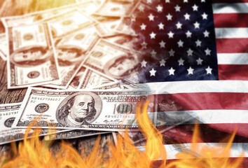 US dollar bank note currency and USA flag burn on fire. the economic crisis in the United States and investors' confidence in the value of the American dollar concept.