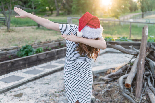 teen girl in xmas hat outdoors, dabbing
