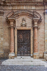one of the decorated wooden doors of the cathedral basilica of Atri in Abruzzo Italy