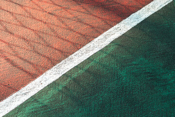 Sport concept. Basketball court on public park with shadow of fences. After edits.