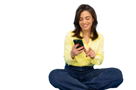 Smiling businesswoman using mobile phone while sitting with legs crossed on transparent background