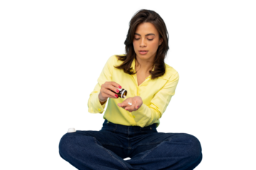Female patient swallowing medication, sitting cross-legged against neutral transparent background