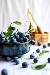 side view of the small sour blue-black sloes ok a black bowl on a white background