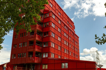 Architectural detail of bright red apartment complex building in Almere, Flevoland. Real estate housing market in The Netherlands
