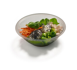 Healthy chicken salad with broccoli carrots spinach and sesame balls