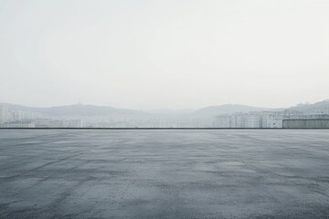 Empty rooftop parking lot overlooking a hazy cityscape.