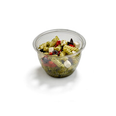 Pasta salad with pesto tomatoes olives and feta in plastic bowl