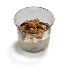 Yogurt parfait with granola and chocolate chunks in clear plastic cup