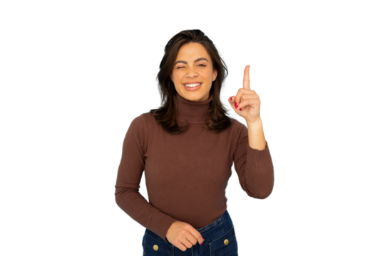 Playful female model pointing upward, smiling with cheeky wink against isolated backdrop