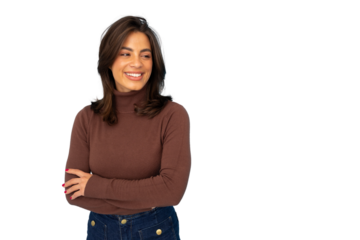 Cheerful young woman standing with crossed arms, glancing sideways with warm smile against transparent backdrop