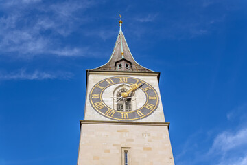 St. Peter Church Clock Tower, Zurich: Iconic Landmark against Blue Sky.Famous Clock Tower with...