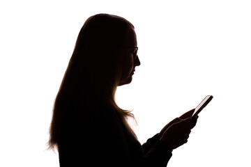 Silhouette of young woman using smartphone on white background