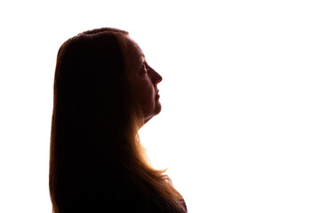 Silhouette of young woman looking up thoughtfully on white background