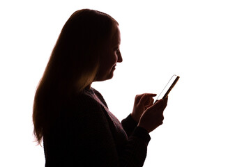 Silhouette of young woman using smartphone on white background
