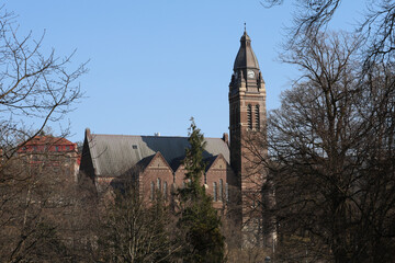 Gothenburg / Sweden, Mar 24, 2025: Annedal Church tower through trees