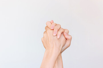 Two woman's hands gripping each other, symbolizing support and friendship.