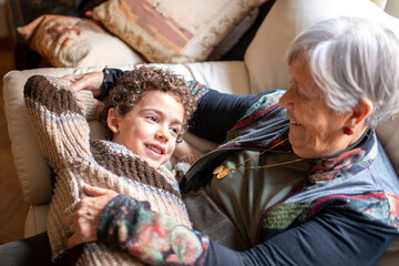 Grandmother and grandchild sharing a loving moment on sofa