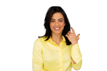 Professional female executive wearing bright yellow blouse, confidently touching hair with polished demeanor against clean transparent backdrop