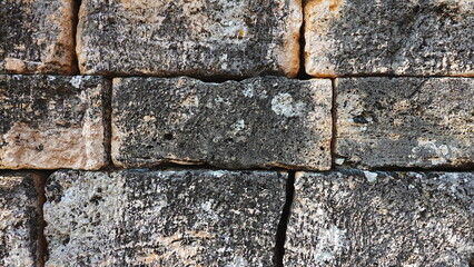Old Stone Wall With Rough Texture In Natural Colors Closeup View