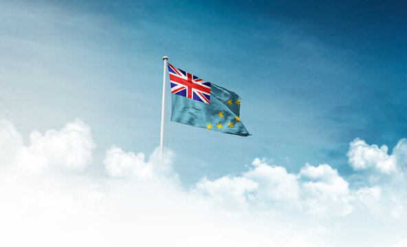 Tuvalu national flag with mast waving in beautiful sky. Tuvalu flag for Republic Day and Independence Day.
