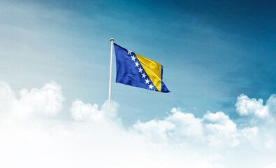 Bosnia and Herzegovina national flag with mast waving in beautiful sky. Bosnia and Herzegovina national flag for independence day.