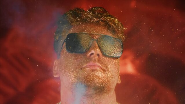 Calmness relax chill face man in gold glitter. Comical photo funny person. Blowing powder, individual refresh. Serenity control stability positive emotion guy in sunglasses.Blow smoke spray gold dust
