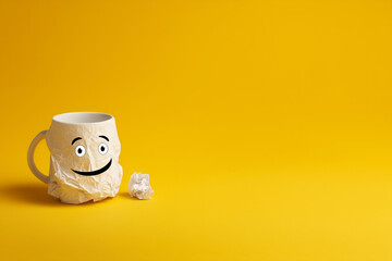 Mug with smiling face on yellow background
