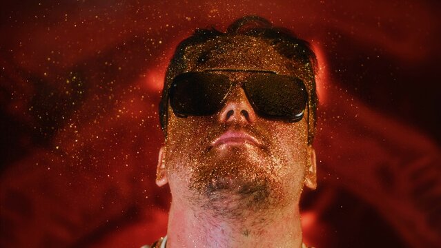 Calmness relax chill face man in gold glitter. Comical photo funny person. Blowing powder, individual refresh. Serenity control stability positive emotion guy in sunglasses.Blow smoke spray gold dust