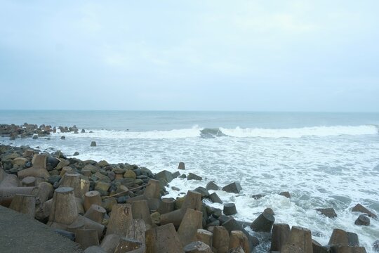 The breakwater at beach on cloudy day. Made from concrete mold. Sea and wave breakers. Pemecah ombak, pemecah gelombang laut