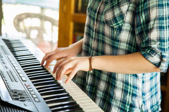 Teen girl playing keyboard