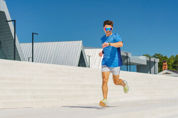 Bright blue skies set the stage for a joyful runner chasing fitness in a modern urban landscape