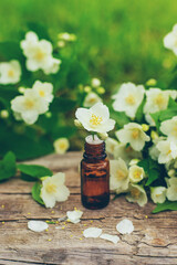 Jasmine essential oil and flowers. Selective focus.