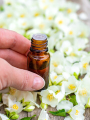Jasmine essential oil and flowers. Selective focus.