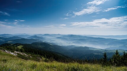 Fototapeta premium Sunlit distant mountains under green-blue sky with fog covering from base to peak. Panoramic wide-angle view in high-definition, natural lighting, warm tones, tranquil and magnificent scenery.